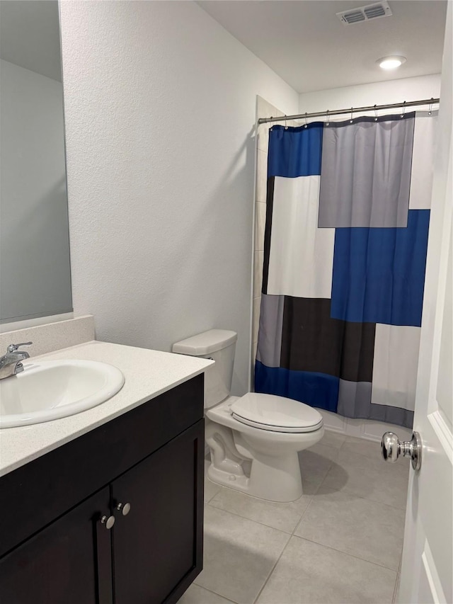 bathroom with tile patterned flooring, vanity, toilet, curtained shower, and visible vents