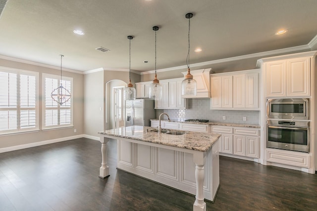1310 Packsaddle Trl, Prosper, TX 75078 - kitchen featuring appliances with stainless steel finishes, a sink, backsplash, visible vents, and custom exhaust hood