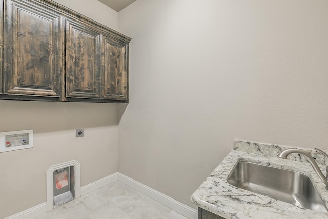 1310 Packsaddle Trl, Prosper, TX 75078 - laundry area with baseboards, hookup for a washing machine, a sink, cabinet space, and hookup for an electric dryer