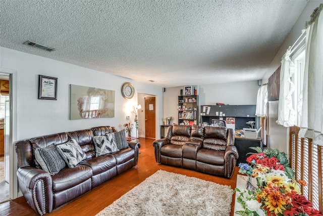 1813 Brook Hollow Dr, Fort Worth, TX 76114 - living room with a textured ceiling, visible vents, and wood finished floors