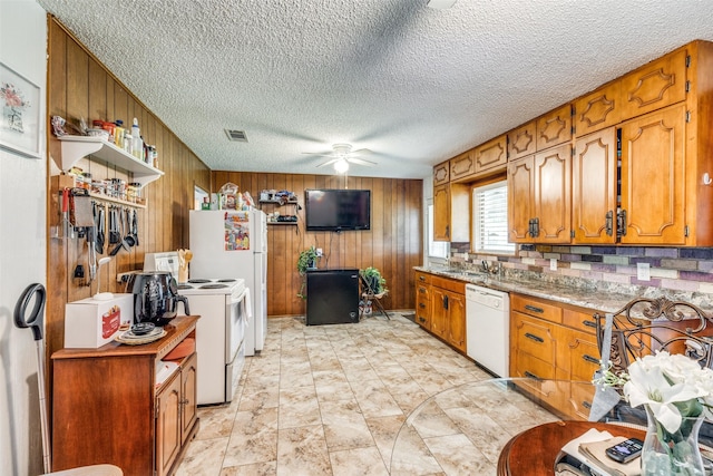 1813 Brook Hollow Dr, Fort Worth, TX 76114 - kitchen with wood walls, ceiling fan, white appliances, and visible vents