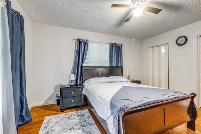 1813 Brook Hollow Dr, Fort Worth, TX 76114 - bedroom featuring baseboards, a ceiling fan, a textured ceiling, and wood finished floors
