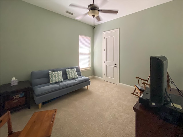 carpeted living room with visible vents, baseboards, and ceiling fan