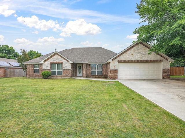 ranch-style home with a garage, a front lawn, fence, roof with shingles, and concrete driveway