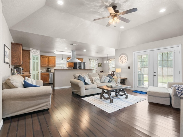 living area with french doors, a ceiling fan, visible vents, dark wood finished floors, and lofted ceiling