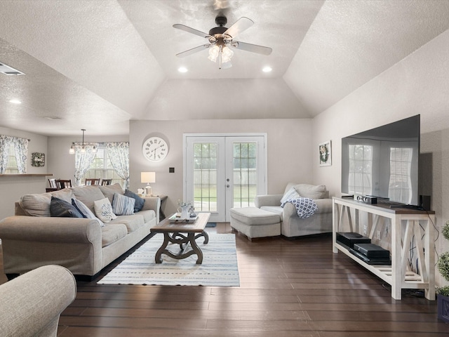 living area with visible vents, dark wood-style flooring, a textured ceiling, french doors, and ceiling fan with notable chandelier