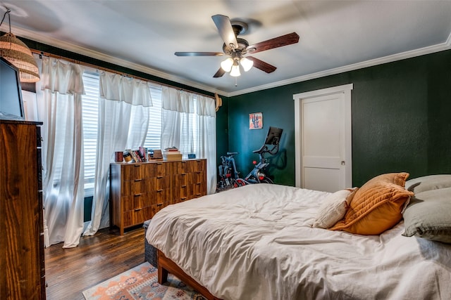 bedroom with ceiling fan, ornamental molding, and wood finished floors