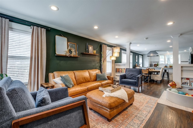 living area featuring recessed lighting, ornate columns, and wood finished floors