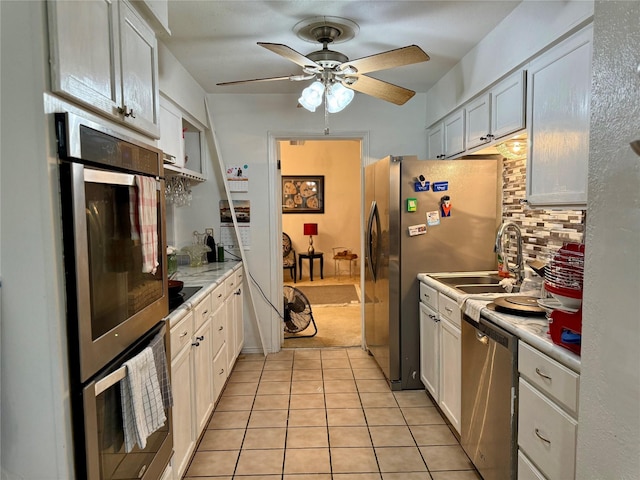321 Chisholm Trl, Sherman, TX 75092 - kitchen with ceiling fan, appliances with stainless steel finishes, a sink, light tile patterned floors, and light countertops