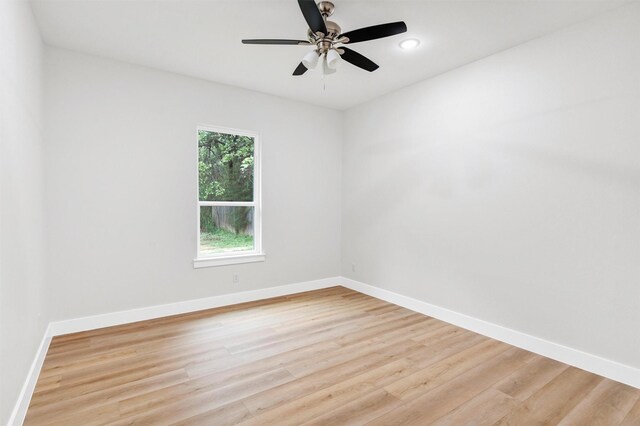 empty room featuring baseboards, recessed lighting, light wood-style flooring, and ceiling fan