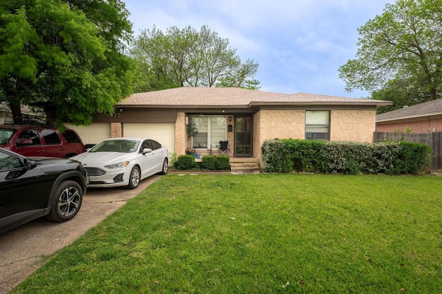 single story home with fence, a front lawn, brick siding, a garage, and driveway
