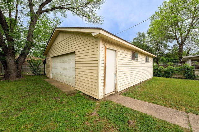 view of outdoor structure featuring fence and an outdoor structure