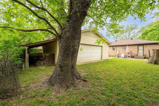 view of yard featuring a garage, a patio, and entry steps