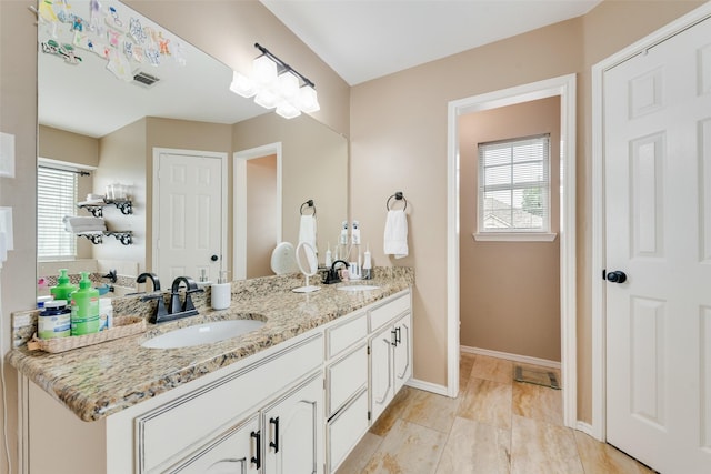 111 Princeton Cir, Forney, TX 75126 - full bath featuring double vanity, baseboards, visible vents, and a sink