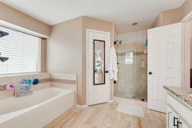 111 Princeton Cir, Forney, TX 75126 - full bathroom featuring vanity, baseboards, a shower stall, and a garden tub