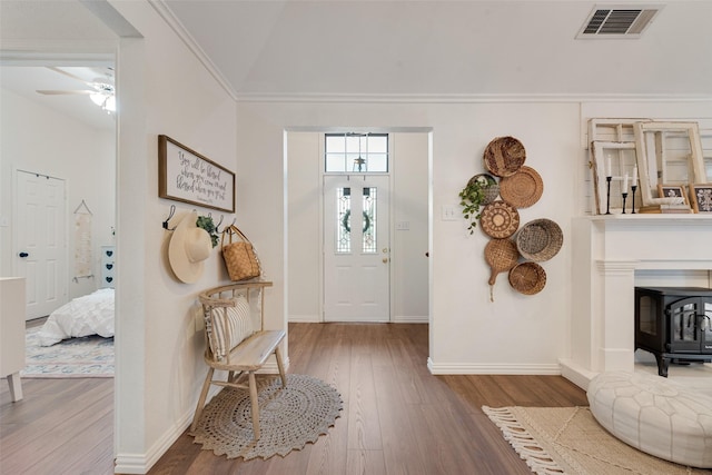 111 Princeton Cir, Forney, TX 75126 - foyer entrance featuring baseboards, visible vents, wood finished floors, and a wood stove