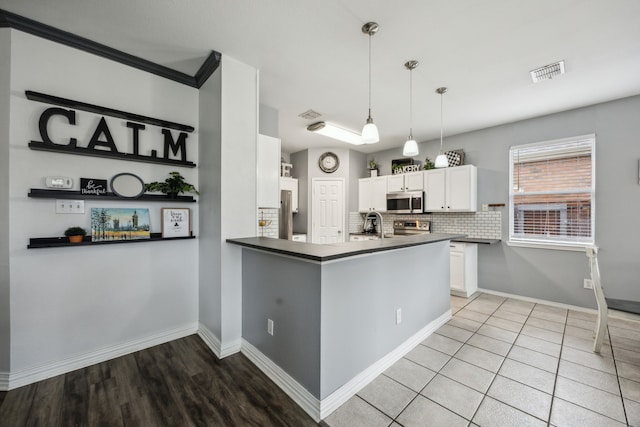10602 Greenbriar Ln, Rowlett, TX 75089 - kitchen featuring backsplash, visible vents, dark countertops, appliances with stainless steel finishes, and white cabinets