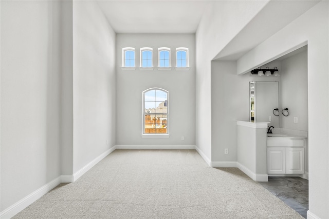 interior space with baseboards and a sink