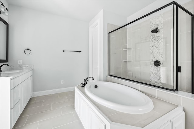 bathroom featuring a garden tub, a shower stall, vanity, baseboards, and tile patterned floors