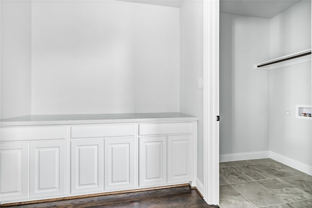 clothes washing area featuring baseboards, hookup for a washing machine, marble finish floor, and cabinet space