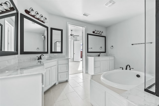 full bath featuring visible vents, a ceiling fan, two vanities, a bath, and a sink