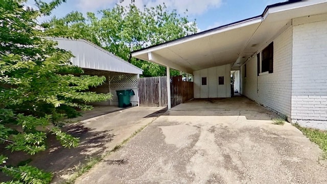 700 N Scarlett Dr, Lacy Lakeview, TX 76705 - view of vehicle parking featuring a carport, fence, and concrete driveway