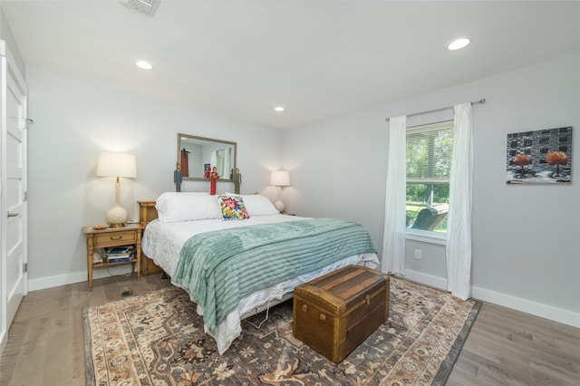 bedroom featuring visible vents, recessed lighting, baseboards, and wood finished floors
