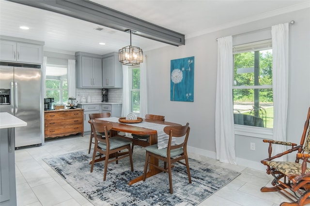 dining room featuring plenty of natural light, crown molding, beam ceiling, and a chandelier