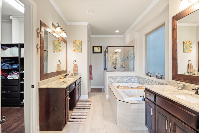 8225 Bonny Bank, The Colony, TX 75056 - bathroom featuring a shower stall, a bath, two vanities, baseboards, and crown molding