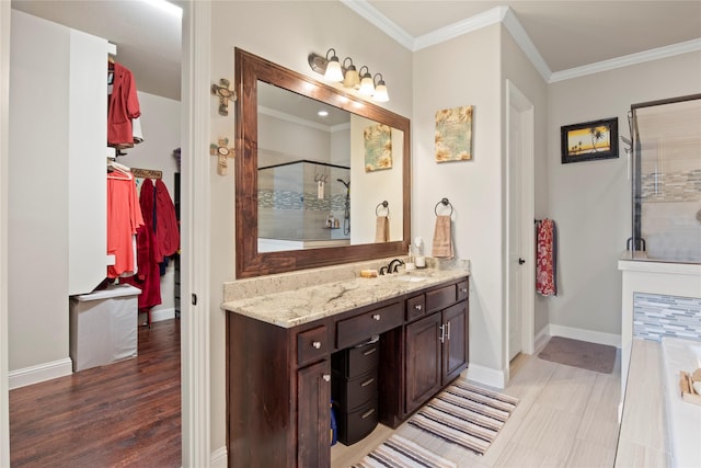 8225 Bonny Bank, The Colony, TX 75056 - bathroom featuring a shower stall, ornamental molding, baseboards, vanity, and a spacious closet
