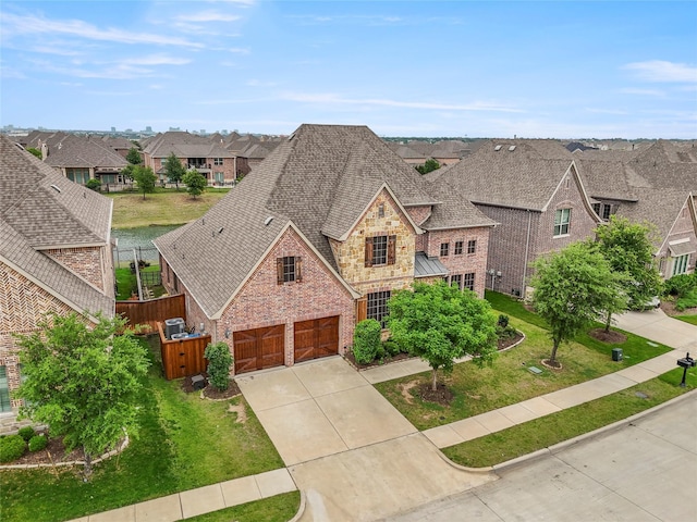 8225 Bonny Bank, The Colony, TX 75056 - view of front of house with stone siding, roof with shingles, concrete driveway, brick siding, and a residential view