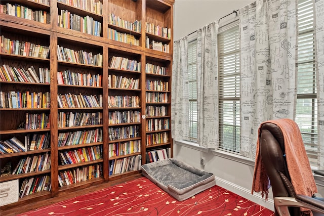 8225 Bonny Bank, The Colony, TX 75056 - living area featuring bookshelves and plenty of natural light