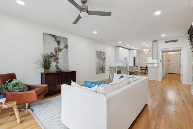living room featuring visible vents, a ceiling fan, light wood-style floors, and recessed lighting