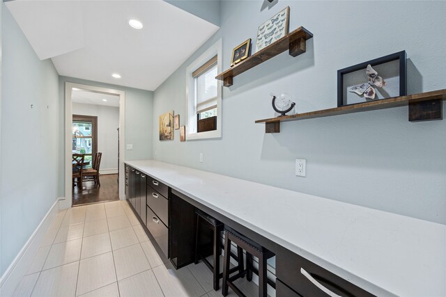 interior space featuring recessed lighting, baseboards, and light tile patterned flooring