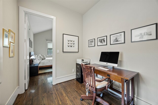home office with baseboards, vaulted ceiling, and dark wood-type flooring