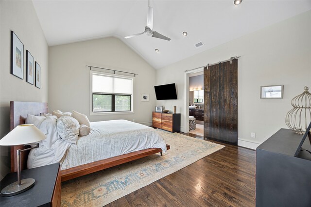 bedroom featuring visible vents, wood finished floors, ceiling fan, a barn door, and vaulted ceiling