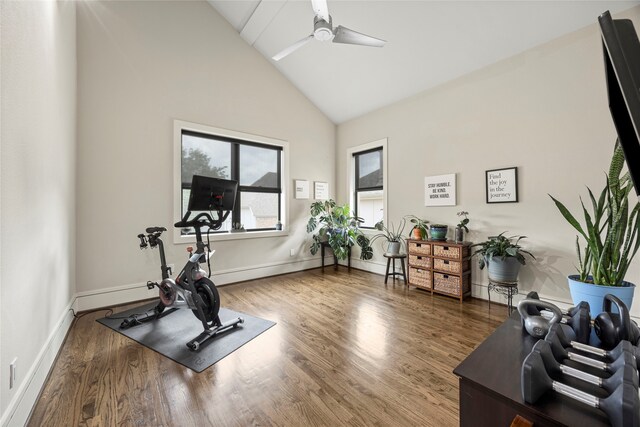 workout room featuring high vaulted ceiling, baseboards, a ceiling fan, and wood finished floors