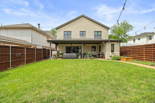 rear view of house featuring a lawn, outdoor lounge area, a ceiling fan, and a fenced backyard