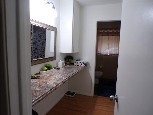 6905 Heritage Ln, Fort Worth, TX 76134 - bathroom with toilet and wood finished floors