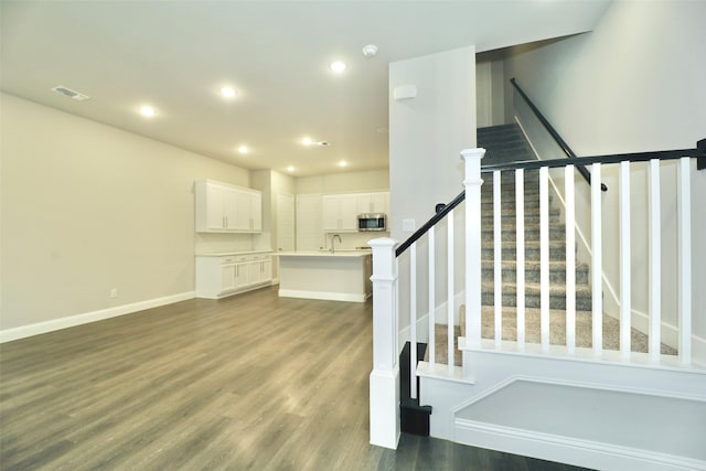 4713 Piedras Lanzar Dr, Mckinney, TX 75070 - stairway featuring baseboards, recessed lighting, wood finished floors, and visible vents