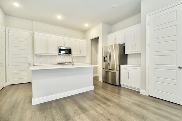 4713 Piedras Lanzar Dr, Mckinney, TX 75070 - kitchen with light countertops, appliances with stainless steel finishes, backsplash, and white cabinets