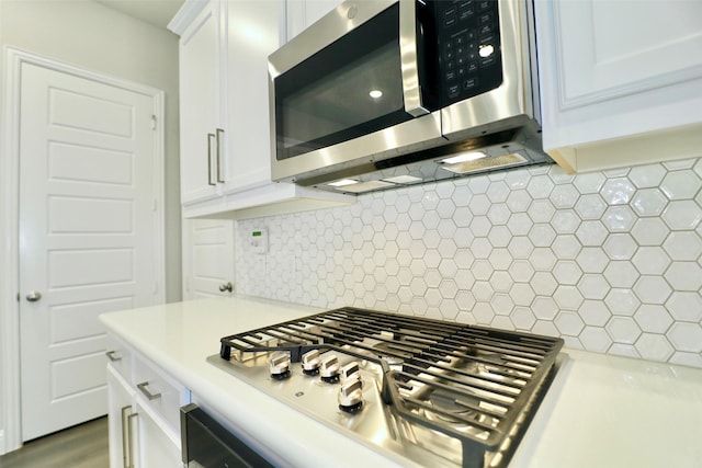 4713 Piedras Lanzar Dr, Mckinney, TX 75070 - kitchen featuring light countertops, white cabinetry, appliances with stainless steel finishes, and decorative backsplash