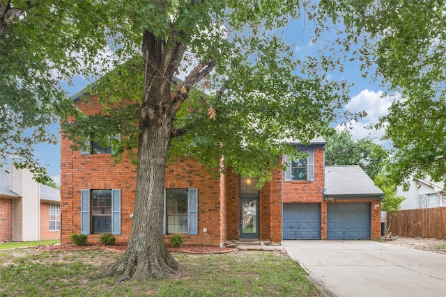 view of front of house featuring brick siding, a garage, fence, and concrete driveway