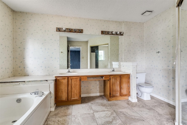 bathroom with a sink, wallpapered walls, and a textured ceiling