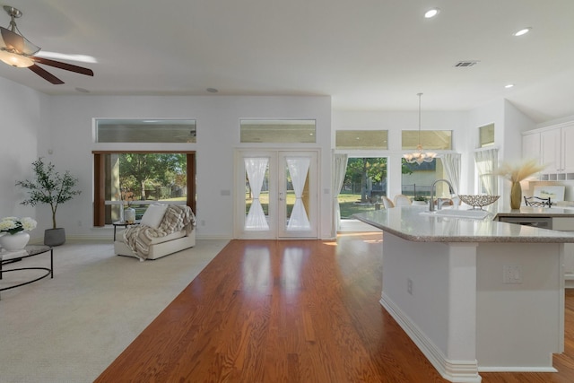 kitchen featuring white cabinetry, visible vents, a wealth of natural light, and a sink