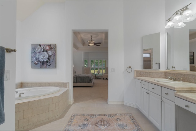 full bathroom featuring vanity, ceiling fan, a bath, tile patterned floors, and ensuite bath