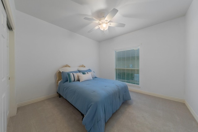 bedroom featuring baseboards, a ceiling fan, and light colored carpet