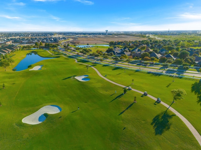 drone / aerial view with a water view, view of golf course, and a residential view
