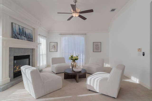 carpeted living room with ceiling fan, visible vents, baseboards, and a fireplace