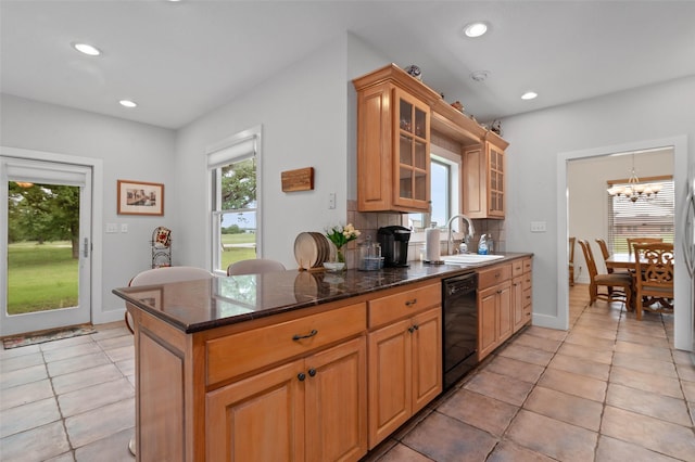 kitchen with a sink, a notable chandelier, black dishwasher, recessed lighting, and light tile patterned flooring